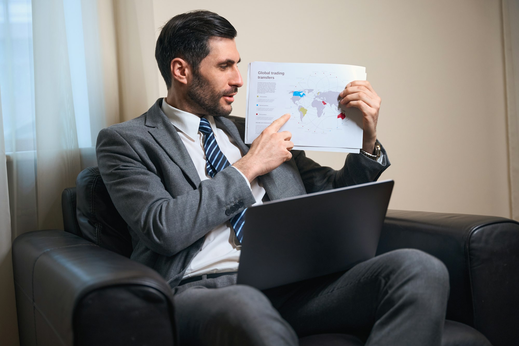 Businessman holds a map of the world in his hands